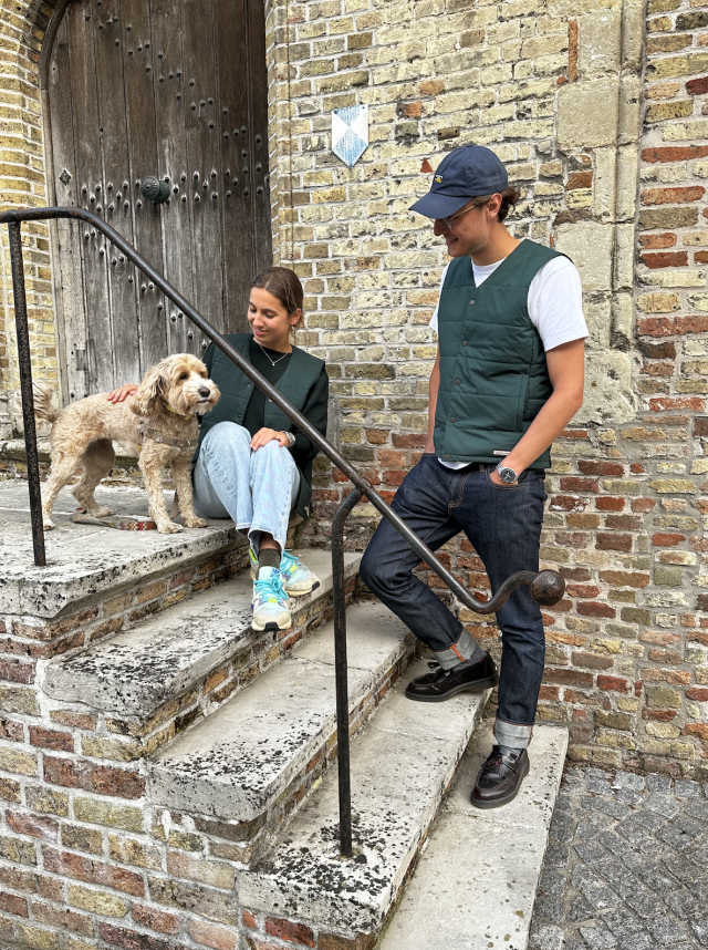 young couple in bottle green v-neck vest