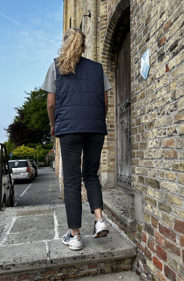 young girl in navy v-neck vest